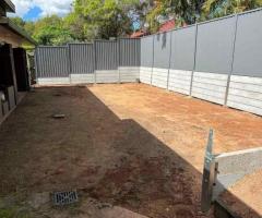 Large dig out, concrete retaining wall and colourbond fencing